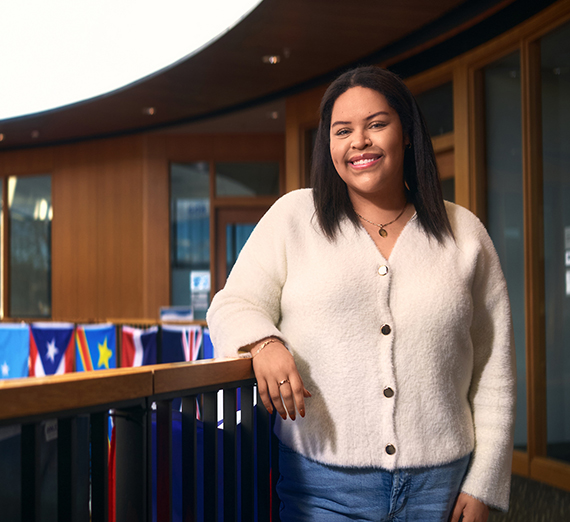 A woman with long hair  smiles at the camera